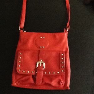 A small red shoulder bag